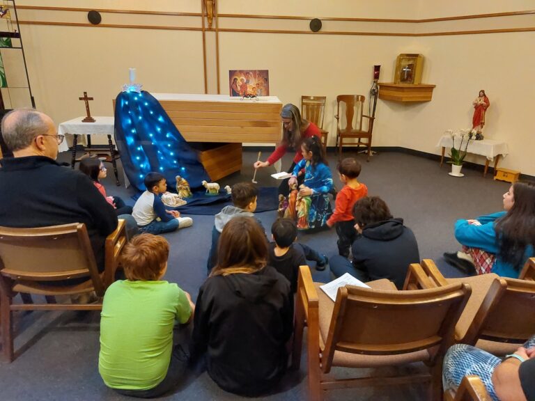 Children gather around a retreat leader in the chapel at St. Charles Retreat Centre for a time of reflection.