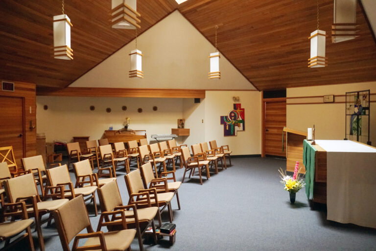 Inside St. Charles Retreat Centre, a chapel with chairs arranged around an altar.